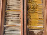 a lot of old records in a box on the table