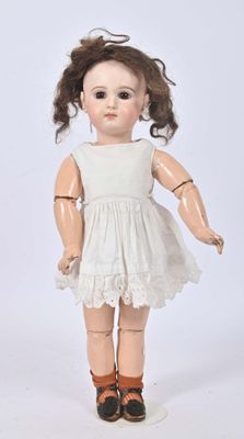 an old fashioned doll with a white dress and brown shoes