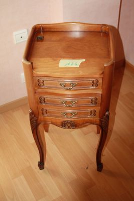 a small wooden table with a drawer on top of it