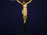une statue de Jésus sur la croix, sur fond bleu