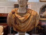 a marble bust of a man sitting on a pedestal