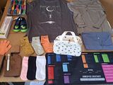 a table with a lot of clothing and gloves on it