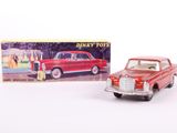 an old red toy car next to a boxed box of disney toys