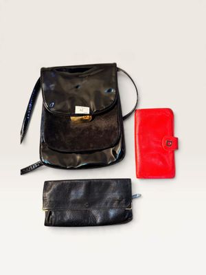 a purse and a wallet on a white surface