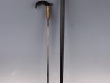 a pair of swords with a wooden handle on a white surface