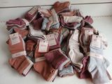 a pile of folded cloths with tags on them