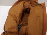 the inside of a brown jacket with a zipper on it