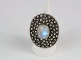a close up of a ring with a rainbow stone in it
