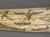 a whale tooth with a drawing of boats on it