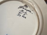a white plate with writing on it sitting on a table