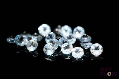 some very pretty blue diamonds on a black surface