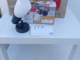 a white table with a lamp and a box on it