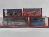 three toy cars are sitting in a display case on a white surface