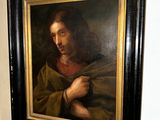 a picture of a painting of jesus hanging on a wall