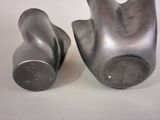 two metal objects that are sitting on a table