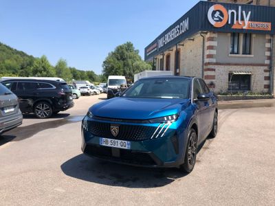 a blue car parked in front of a building in a parking lot