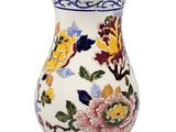 a white vase with colorful flowers on it on a white background