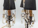 pair of black and gold table lamps with black shades on them