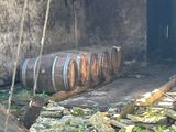 many barrels that are stacked on the ground next to each other