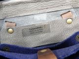 a close up of a purse with a label on it