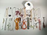 a lot of necklaces and bracelets on the table