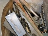 a large metal box filled with tools and a saw