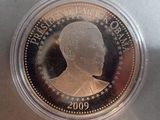 a close up of a coin in a plastic container on a table
