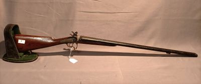 an old rifle with a wooden barrel and a green handle