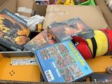 a cardboard box full of toys and books for sale