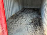 a red door that is open in a container