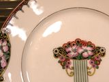 two plates with flowers on them sitting on a table