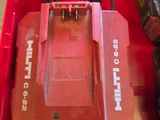 a red tool box with tools in it on the floor
