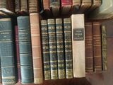 many old books on a shelf in a library