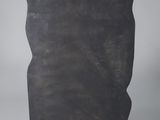 a black stone sculpture on a black base