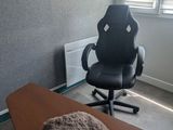 a desk with a chair and a blanket on it