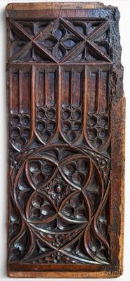 an old wooden panel with a design on it on a wall
