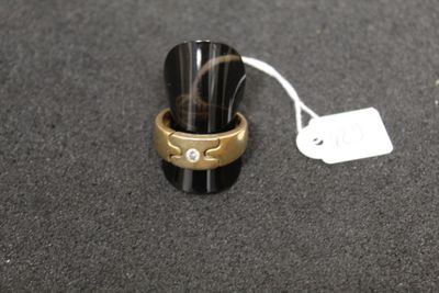 a ring with a diamond on it sitting next to a price tag