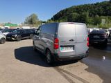 a silver van that is parked in a parking lot