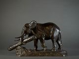 statue of an elephant holding a log in its trunk