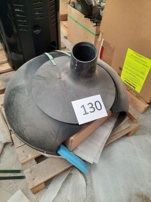 a large metal object sitting on a pallet next to a cardboard box