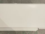 toilet paper dispenser on a tiled floor in a bathroom