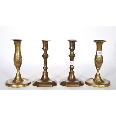 three brass candlesticks are sitting side by side on a white background