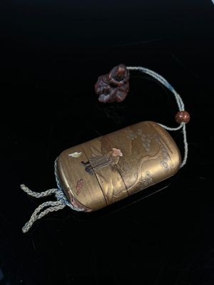 a small metal case with a rope around it