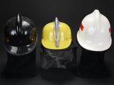 three hard hats sitting on top of each other on a black surface