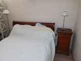 a bed with a white comforter in a small room