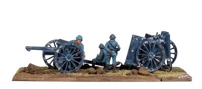 two figurines of men standing next to a cannon on a wooden base