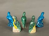three figurines of birds sitting on top of each other