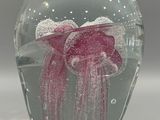 a glass vase with a pink jelly inside of it