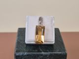 a bottle of perfume sitting on top of a marble block