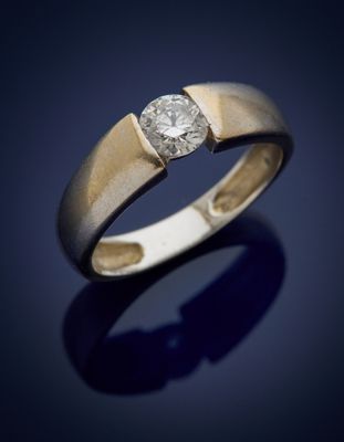 a close up of a gold ring with a diamond on it